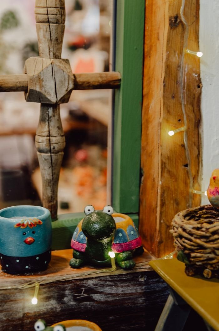 gallery-1 Charming ceramic figurines in a rustic window setting, perfect for warm home decor.