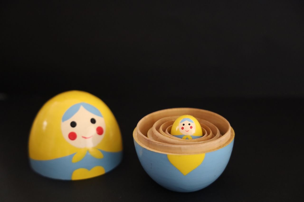 gallery-5 Colorful Matryoshka dolls on black background, showcasing Russian craftsmanship.
