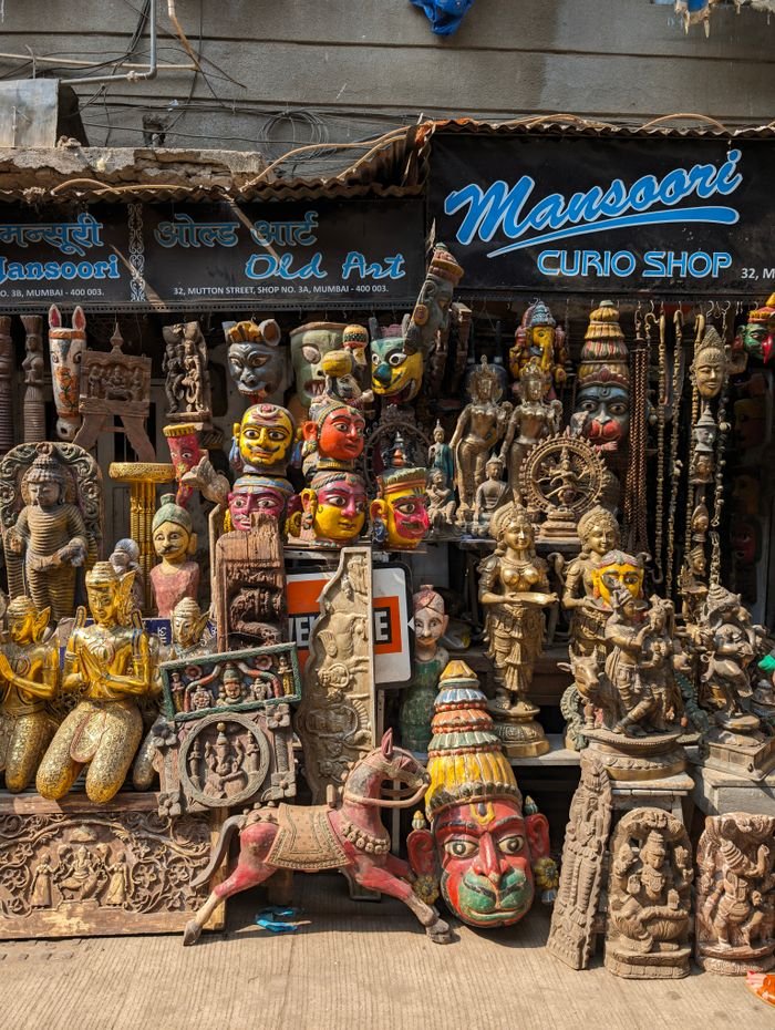 services-01 Vibrant collection of traditional sculptures and curios displayed at a shop in Mumbai, India.