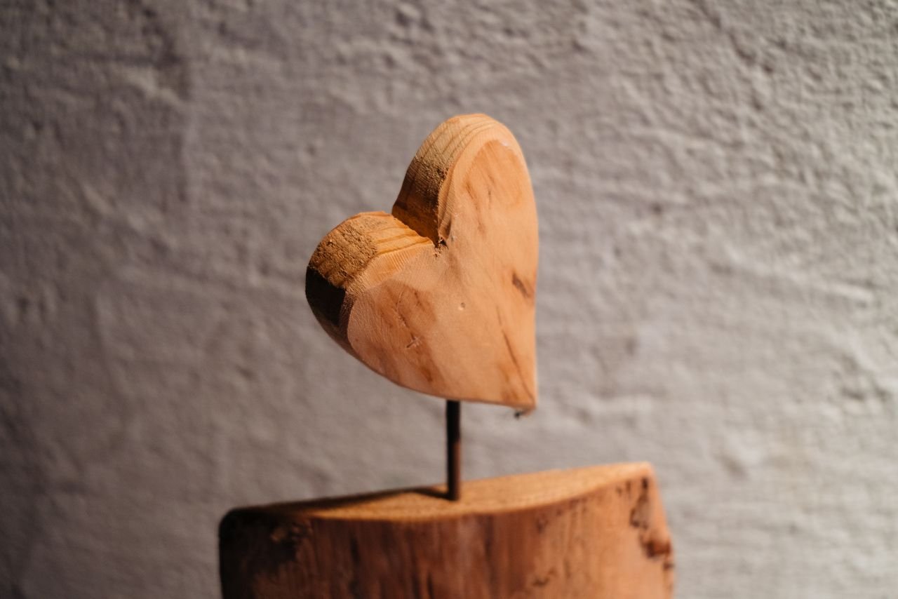 services-01 A close-up of a rustic wooden heart sculpture, ideal for romantic or artistic decor.